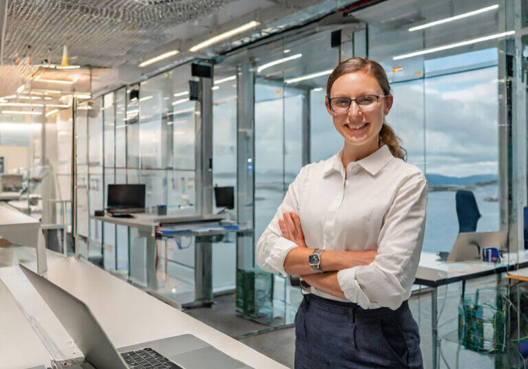 A software developer working in a spacious and light office space within the maritime busine