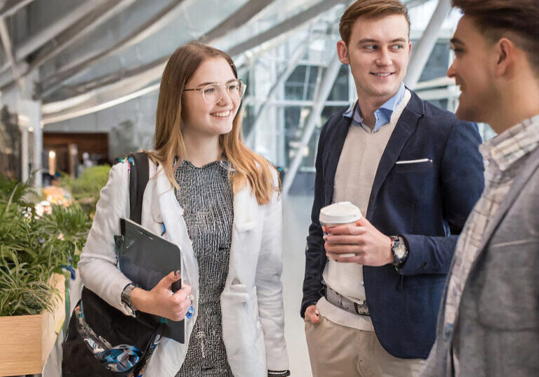 Technology students at career day standing in a large and light lobby